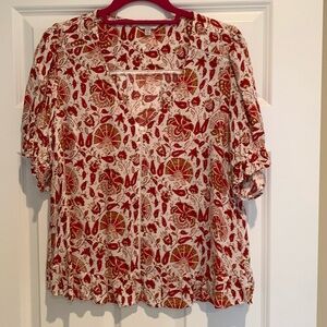 Lucky brand top with ruffled bottom, v neck in a red/rust pattern.  Size Large.
